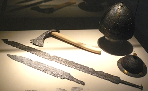 Foto mostrando machado, espadas e capacetes dos guerreiros francos