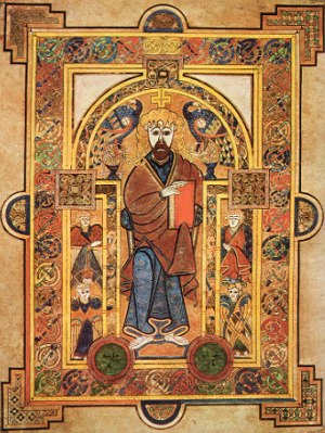 Imagem de uma iluminura medieval mostrando um religioso segurando um livro.